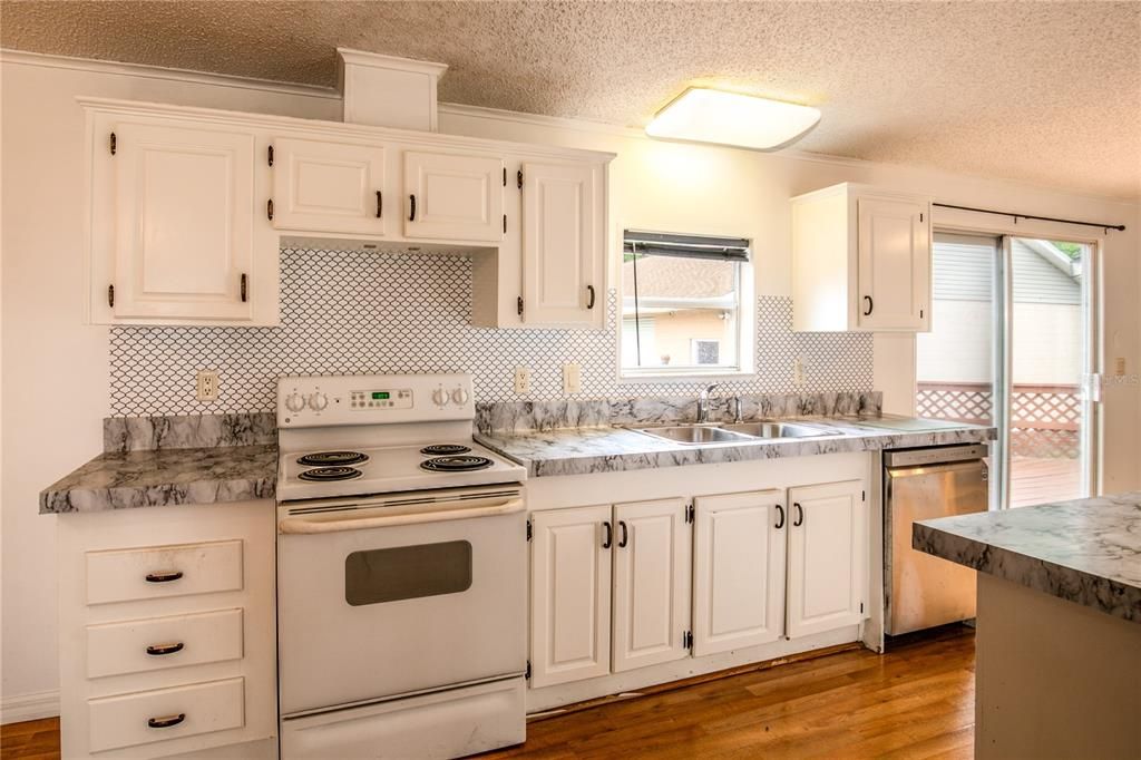 The brightly lit kitchen offers plenty of cabinet storage.