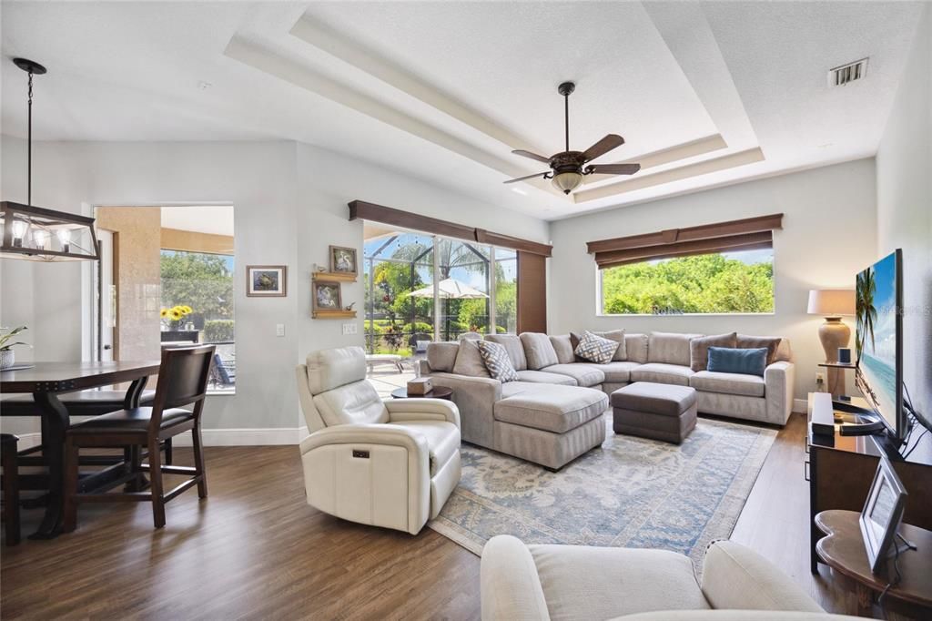 Cozy yet spacious family room with double tray ceilings delivering luxury and elegance.