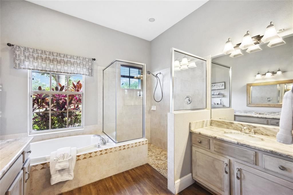 Primary bathroom has double vanity and beautiful modern style wood cabinetry.