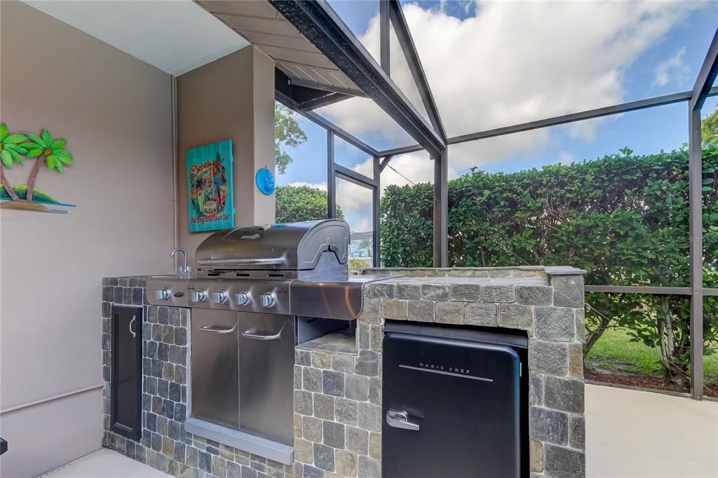 Outdoor grill area with refrigerator