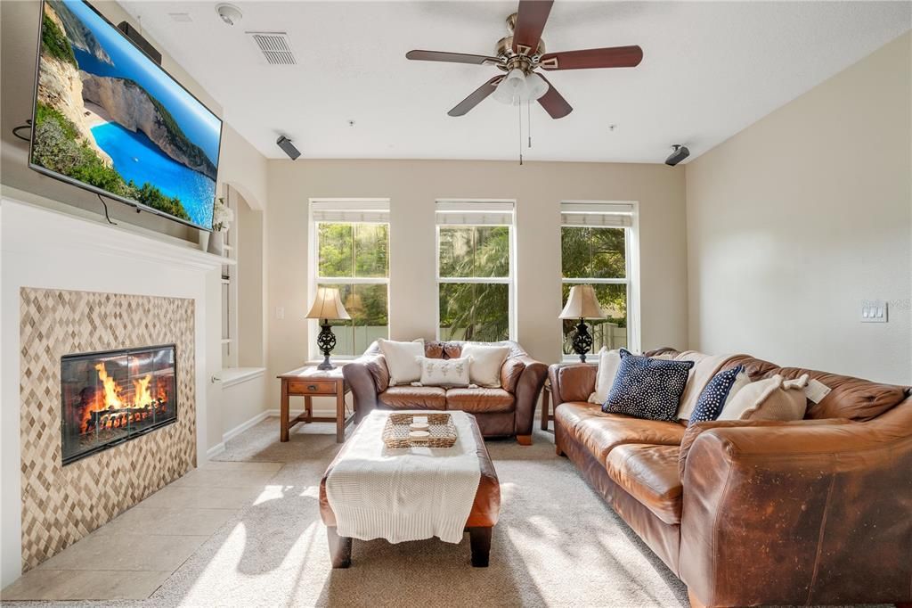 Open living room with liquid propane gas fireplace in Baldwin Park home