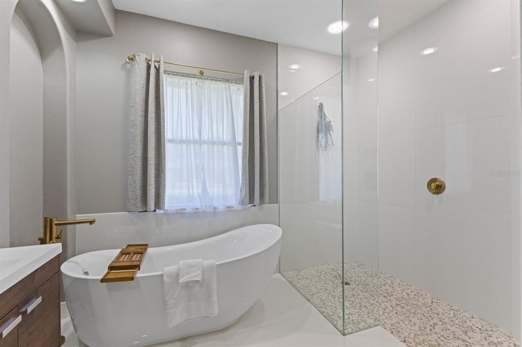 EnSuite Primary Bath completely renovated with top of the line cabinets, stand alone garden tub, and walk in shower