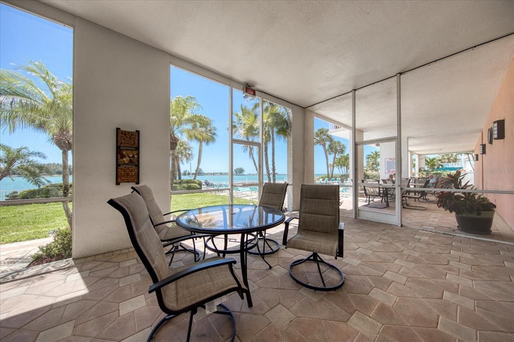 Screened-in social gathering area looking out to pool and Private Beach at Clearwater Pass