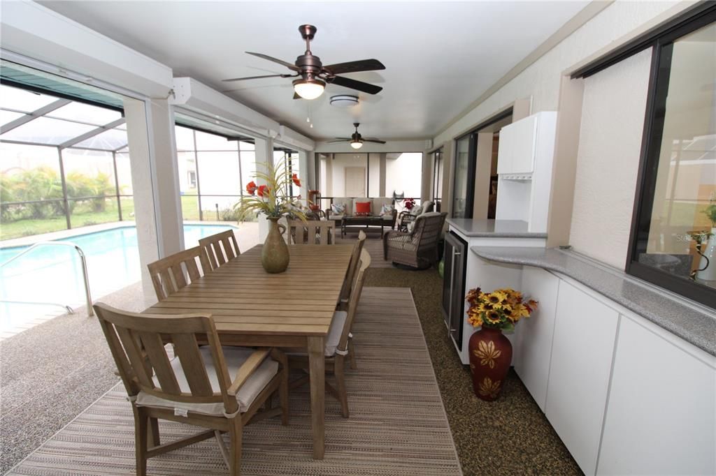 Long Covered Lanai area ... built-in cabinets with wine fridge....