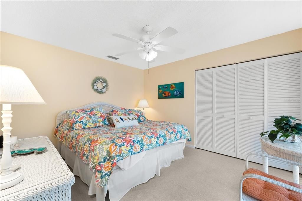 Large guest bedroom in main house that has a king bed.