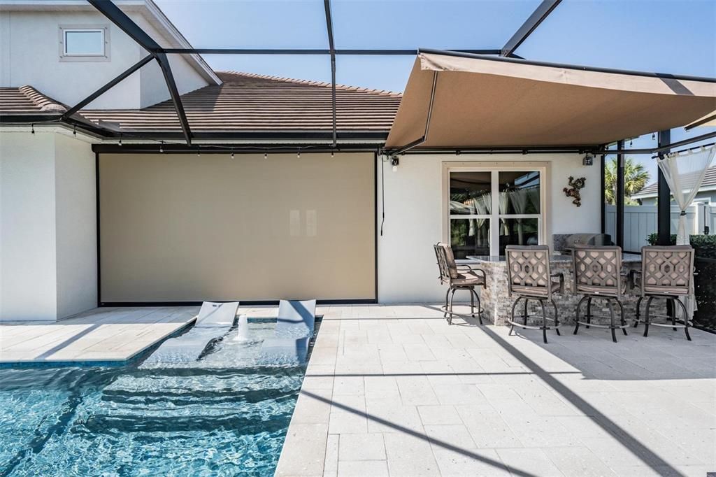 Outdoor kitchen with remote controlled awning, sun shade lanai screen is see through from inside but not from outside!