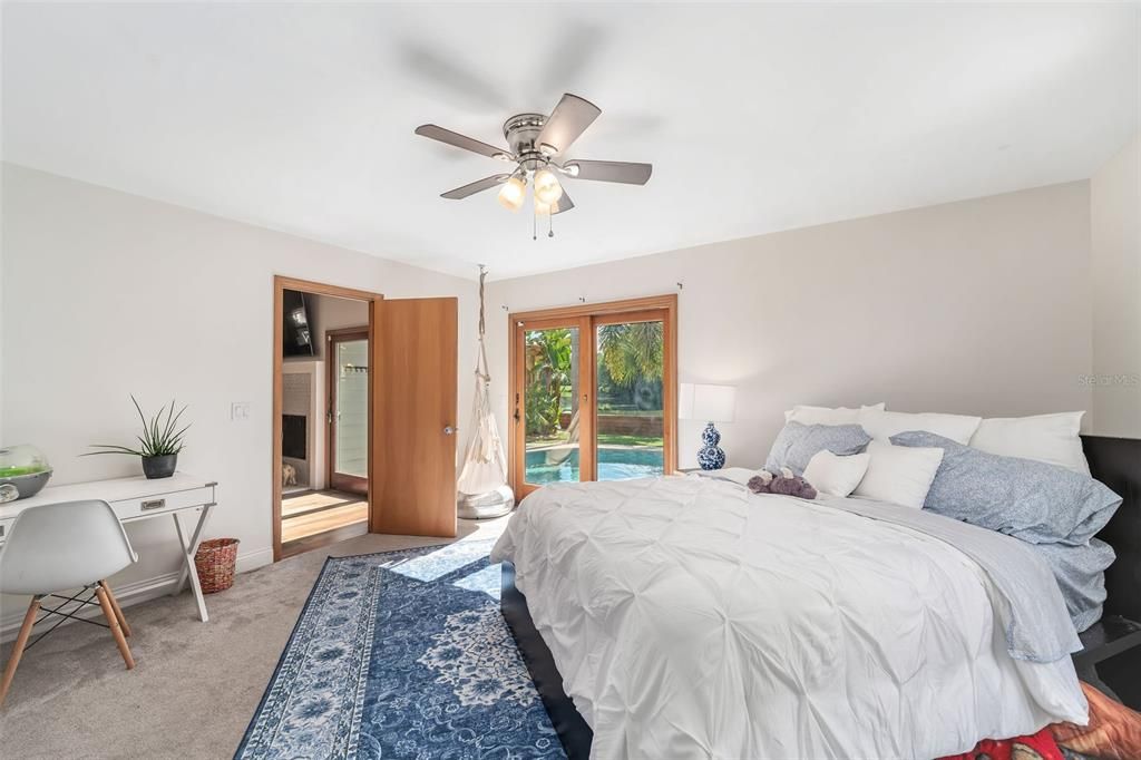 Downstairs bedroom with doors to pool