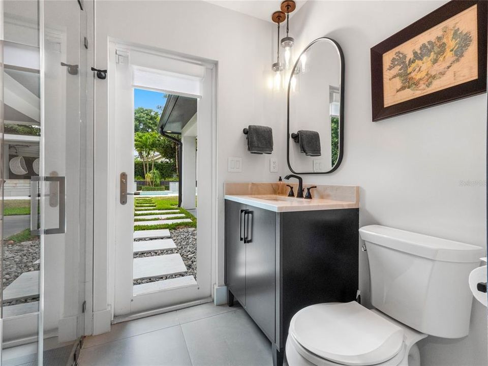 En-suite bathroom two with door to the backyard and pool