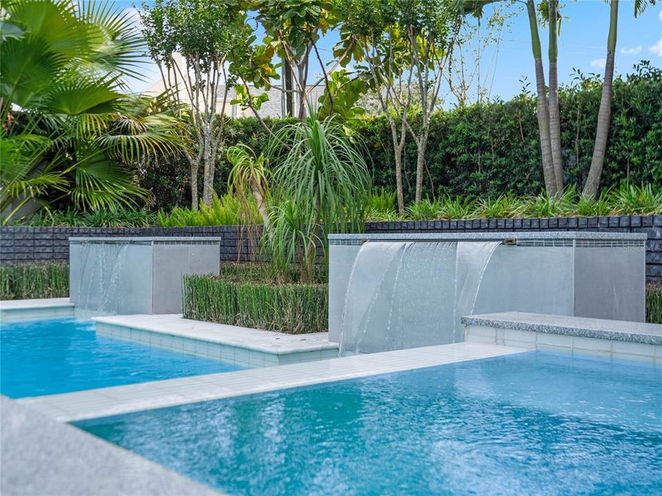 Backyard open air pool with double fountains