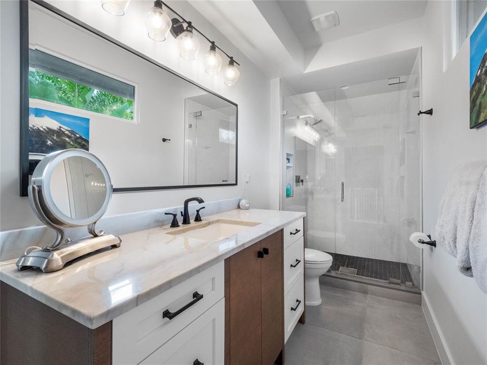 Master bath features a large walk-in shower with frameless shower door