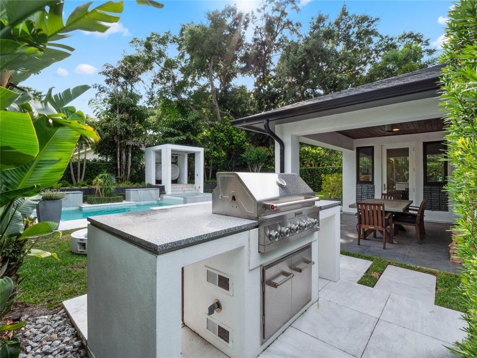 Outdoor kitchen off the covered patio is perfect for a backyard party