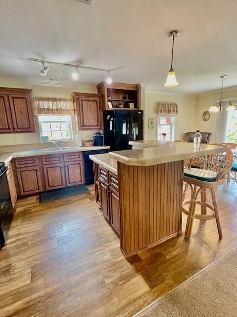 Island in Kitchen with a high top breakfast bar two swivel bar stools