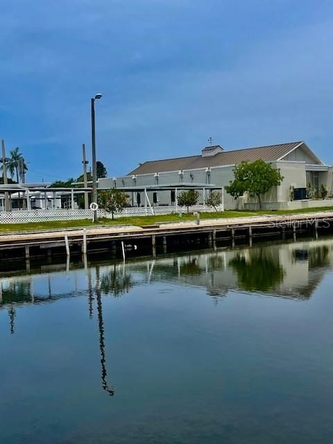 Views   of clubhouse and shuffle board court across pond