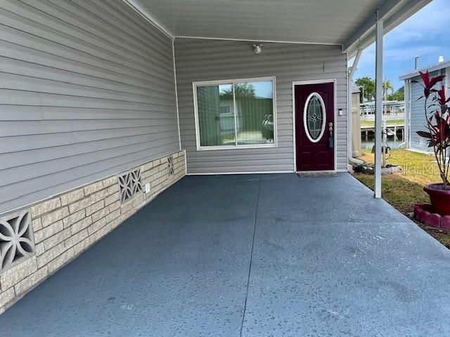 Wide Carport  enters into the Florida room