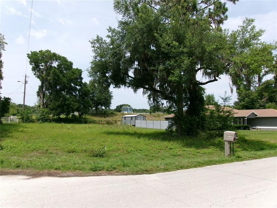 fence on east side and back, farm in the back.  lot faces south