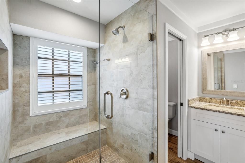 BEAUTIFULLY RENOVAYED PRIMARY BATH INCLUDING CUSTOM OVERSIZED SHOWER with FRAMELESS GLASS DOORS, NEW FLOORING and NEW VANITIES, NEW FIXTURES AND QUARTZ COUNTERTOPS as well!