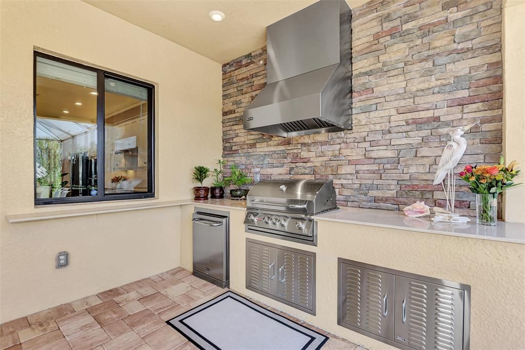 The lanai has a storm smart screen and outside kitchen.