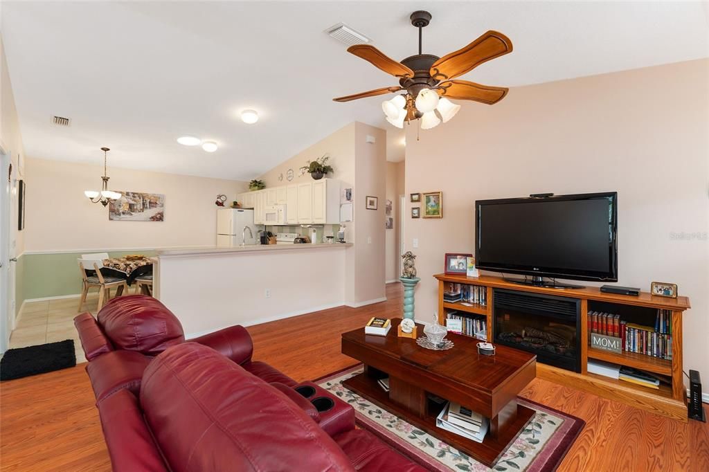 LIVING ROOM HAS LARGE FLAT SCREEN TV, COFFEE TABLE WITH LIFT TOP, LIGHTED CEILING FAN