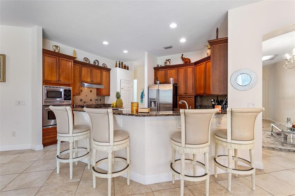 kitchen with an abundance of windows overlooking cory lake, conservation, and pool