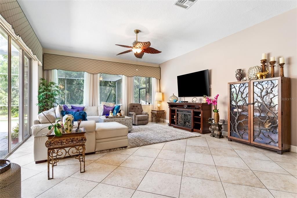 kitchen with an abundance of windows overlooking cory lake, conservation, and pool