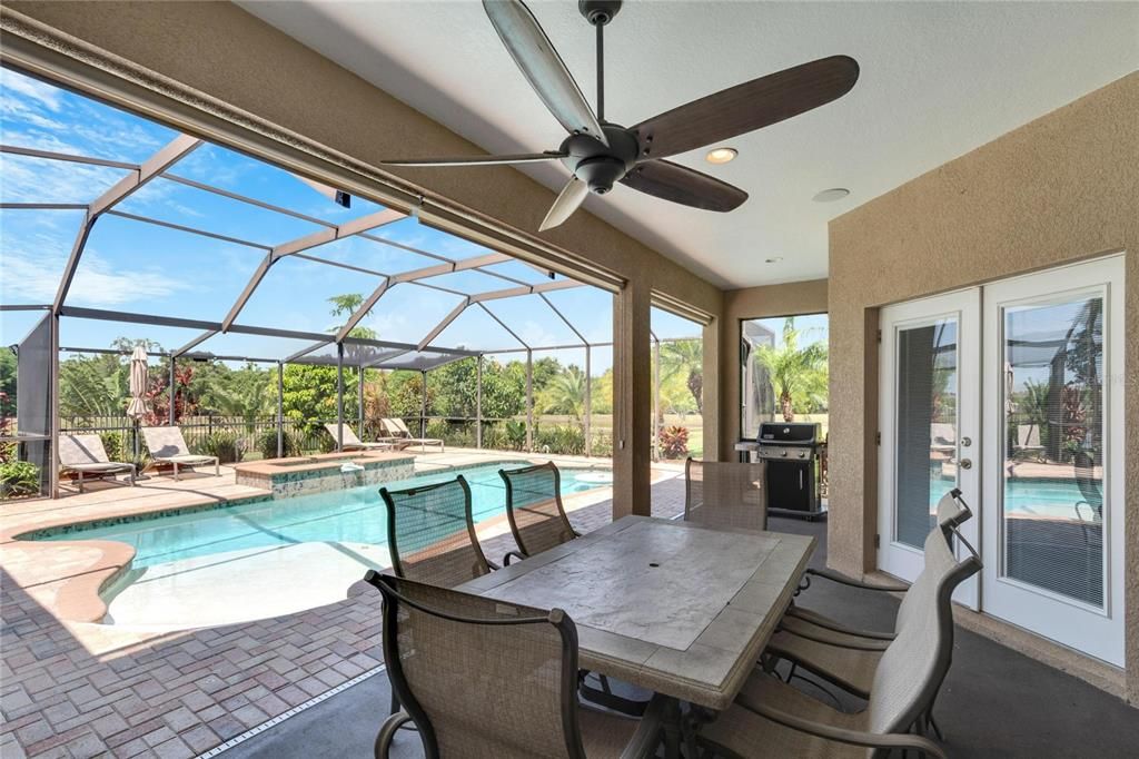 Ultimate Florida living with covered seating, spa, pool and extended pool cage