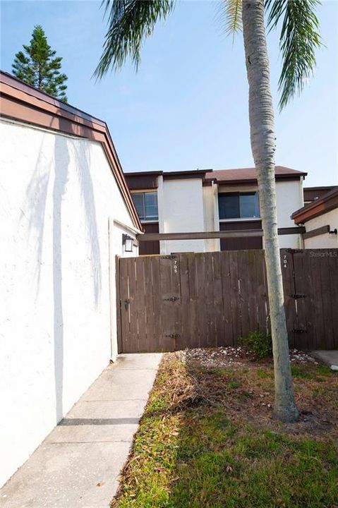 Walkway pass garage to fence access.