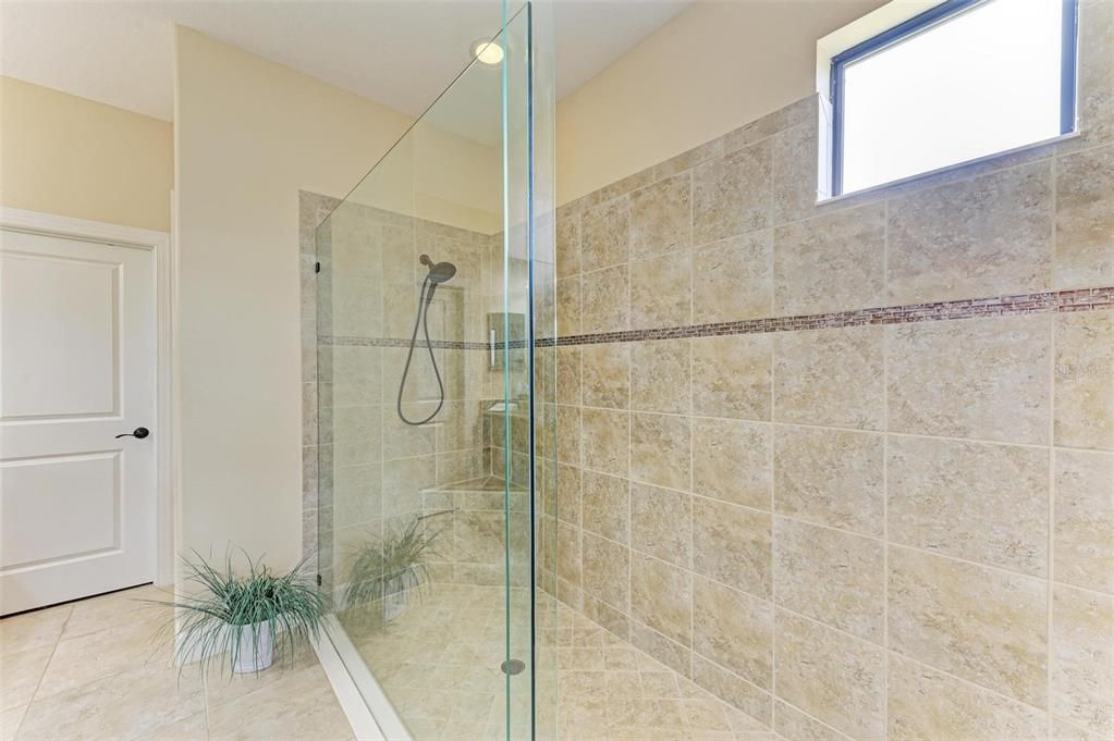 Primary Shower with seamless glass  and decorative listelle