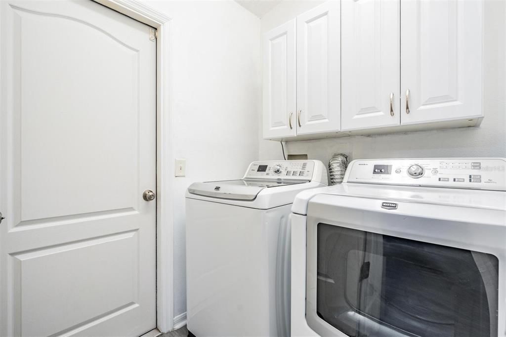 Walk-in laundry room provides built-in storage