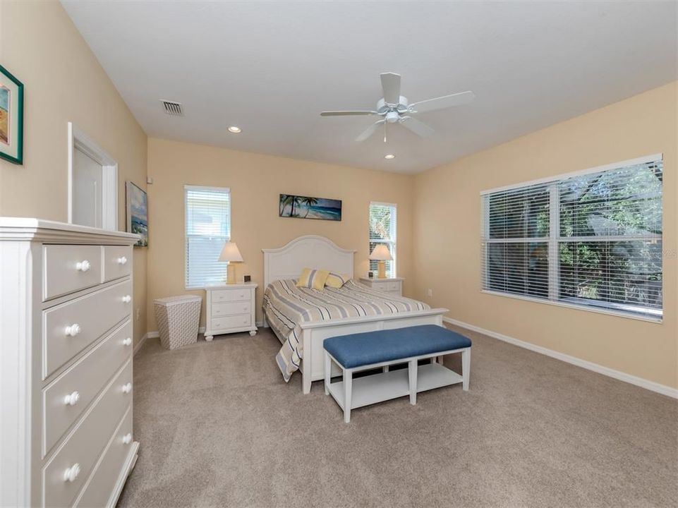 PRIMARY BEDROOM WITH VIEW OF POOL AND PRESERVE