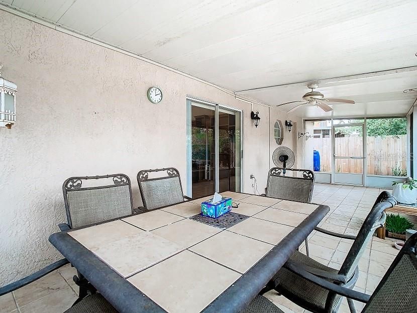 The screened lanai has tile floors and a ceiling fan