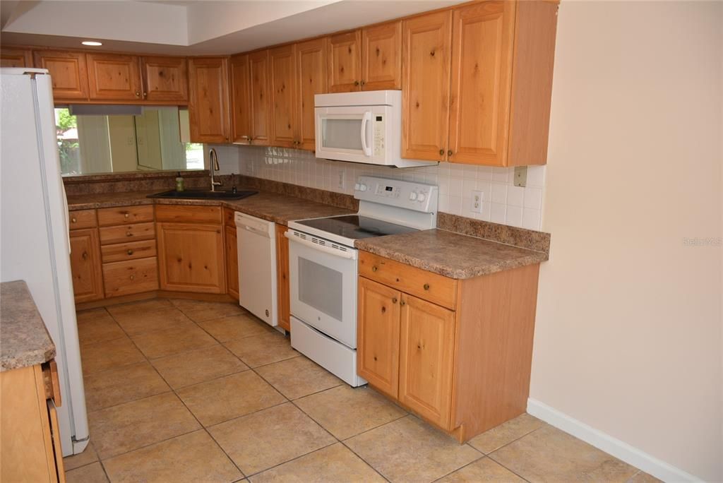 Kitchen comes with all appliances including side-by-side refrigerator, oven/range, space saver microwave and dishwasher