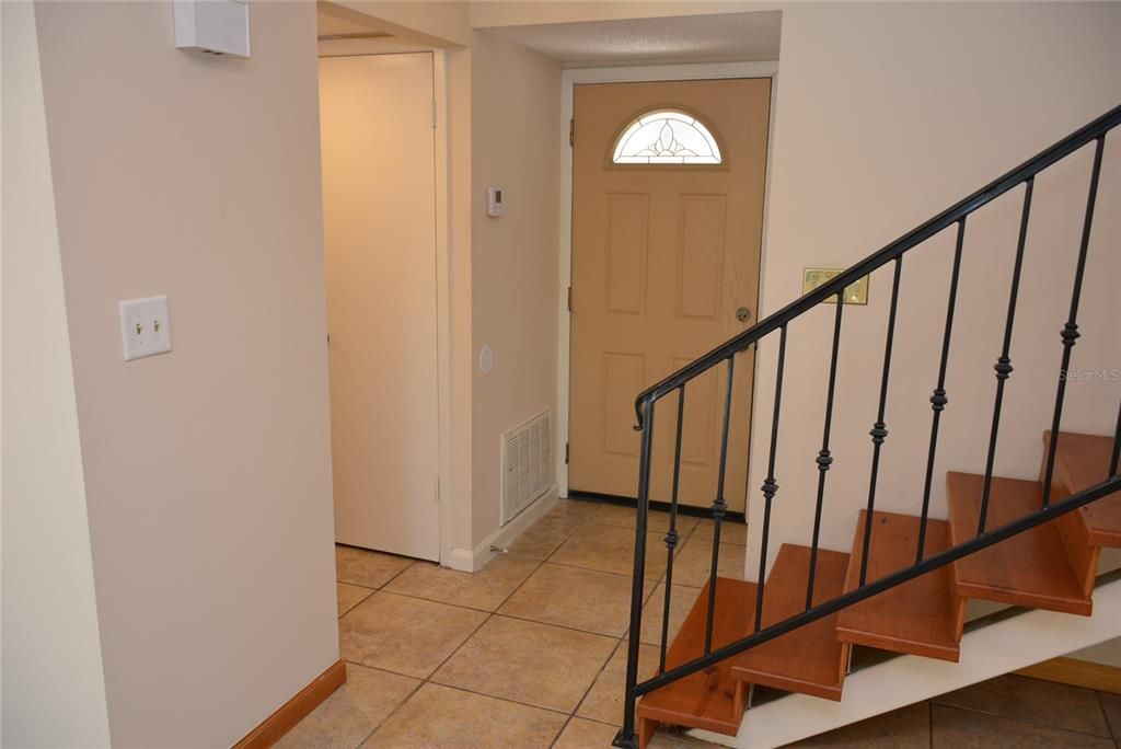 Enter the foyer and Guest half-bath to the right.  Kitchen entrance is to the left.