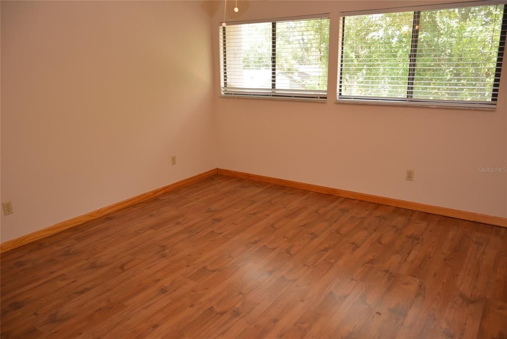 Spacious 13 x 13 2nd bedroom is freshly painted with laminate flooring
