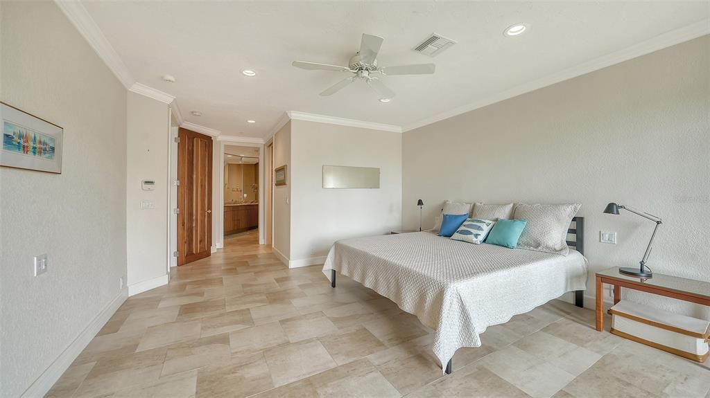 Another view of the primary suite looking towards the huge walk-in closet and spa-like bathroom.