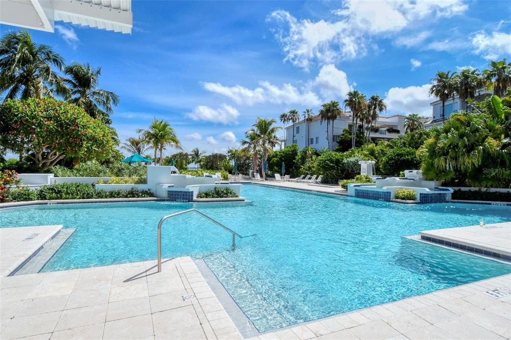 Resort-size, heated pool, complete with waterfalls, is set on a center islandthat has a hot tub.