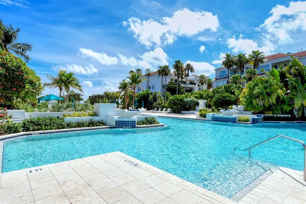 Resort-size, heated pool, complete with waterfalls, is set on a center islandthat has a hot tub.