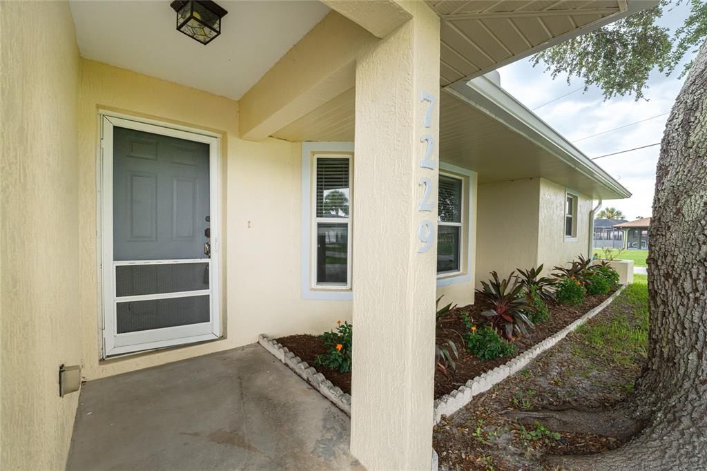 Covered entry area and nice tropical landscaping!