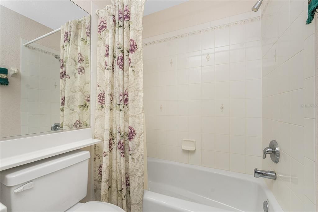 Guest bath has combo tub/shower.