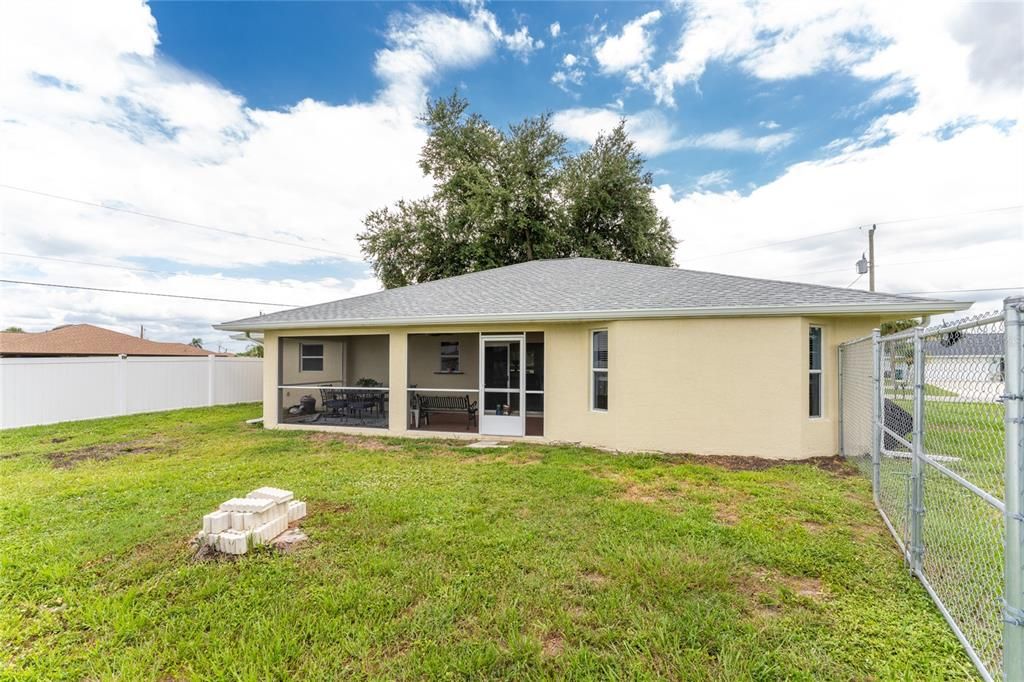 Rear view of the home, showing the location of both the chain link fence and the vinyl fence.