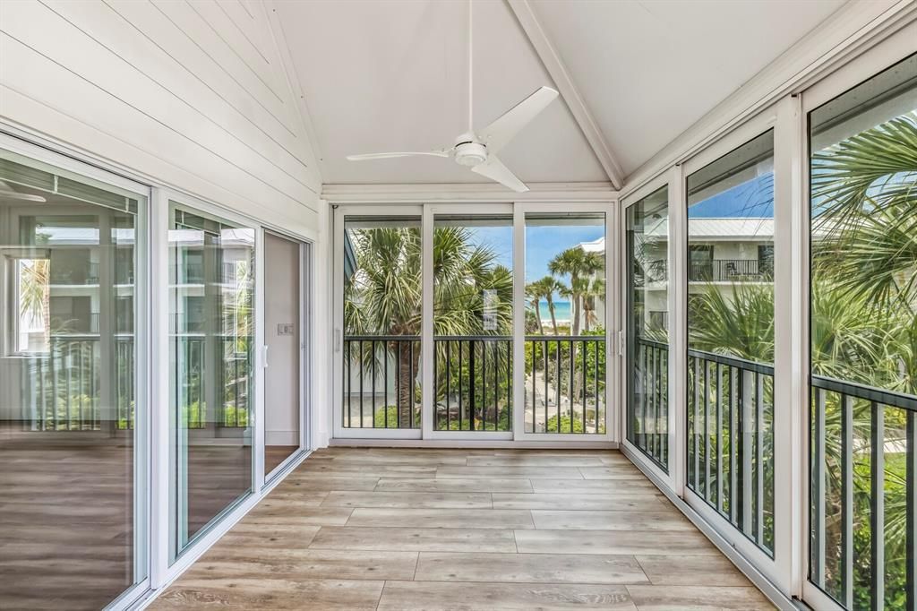 Beautifully enclosed corner porch with Gulf peeks to extend the living room. Could be used as an office, right outside the primary bedroom.