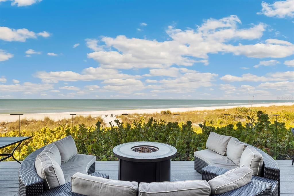 First Floor outdoor sitting area with gas fire pit and clear, glass safety railings providing unobstructed views of the Gulf!