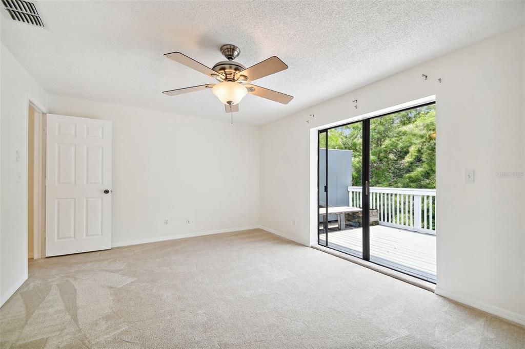 primary bedroom leads to large deck overlooking greenbelt