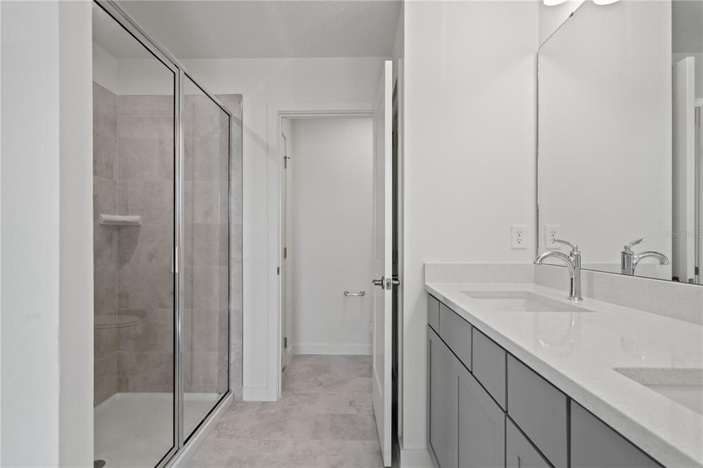 Shower with doors and private water closet.