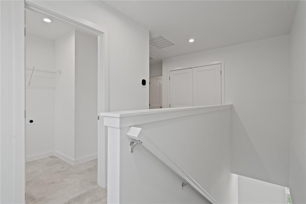 Upstairs landing with dedicated laundry room.