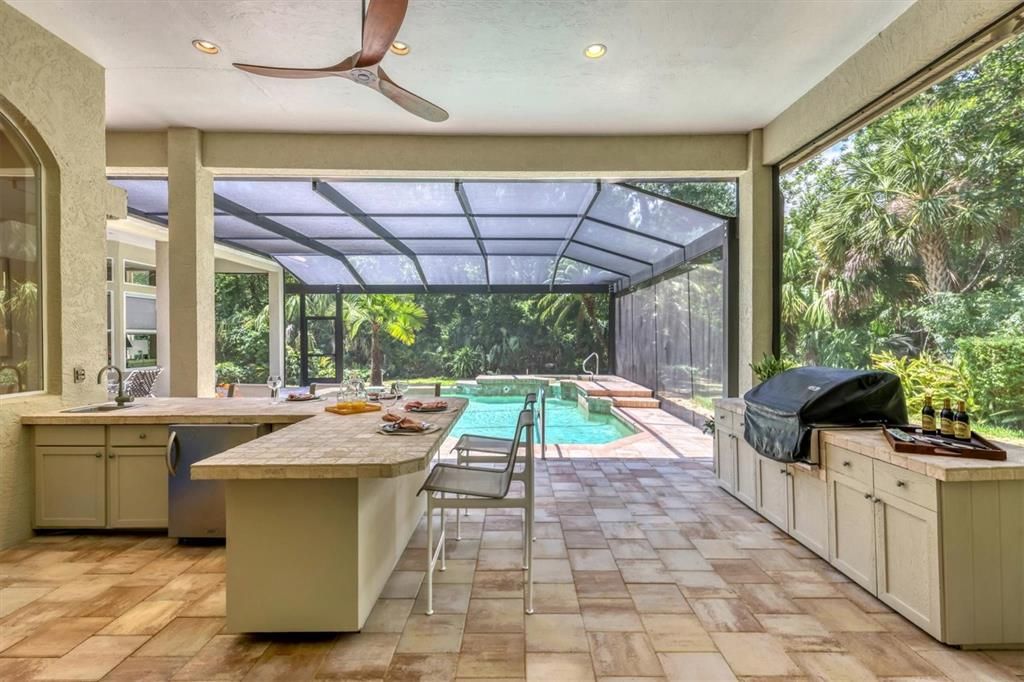 One of two covered lanai entertaining areas, summer kitchen, outdoor dining area