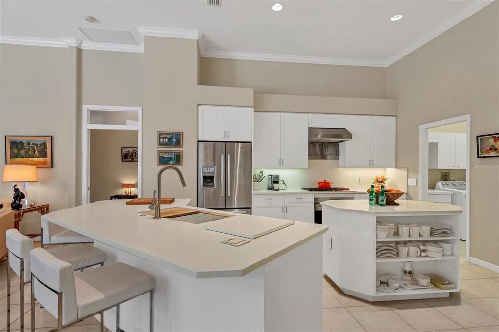 Wolf gas cook top, two ovens ( one in center island) custom stainless hood , French door refrigerator