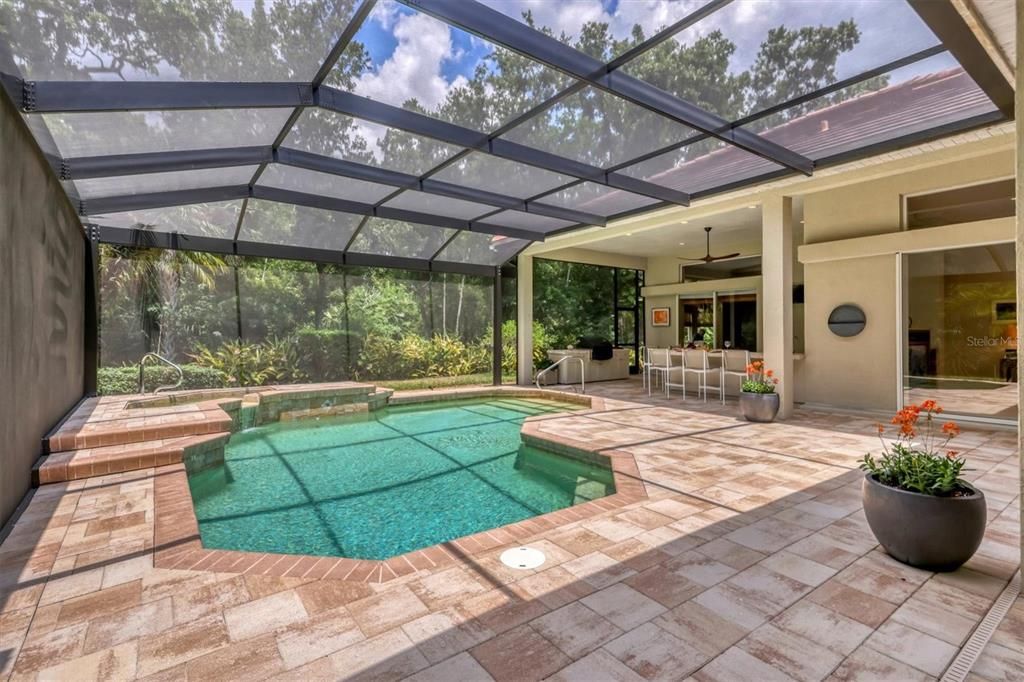 Paverbrick decking, heated pool and spa ( gas and solar), newly installed screen enclosure, summer kitchen and entertaining space surrounded by lush tropical plantings..simply beautiful