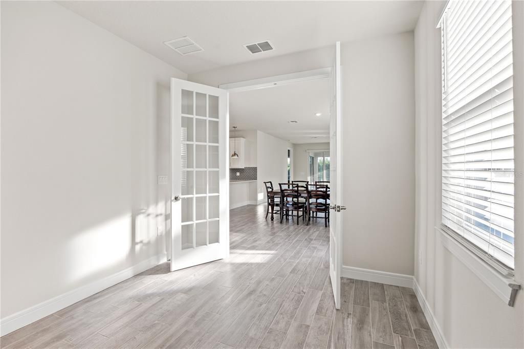 Enclosed flex room w/glass french doors