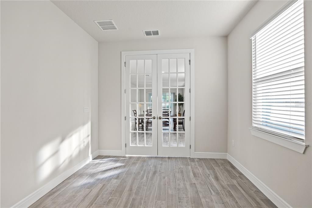 Enclosed flex room w/glass french doors