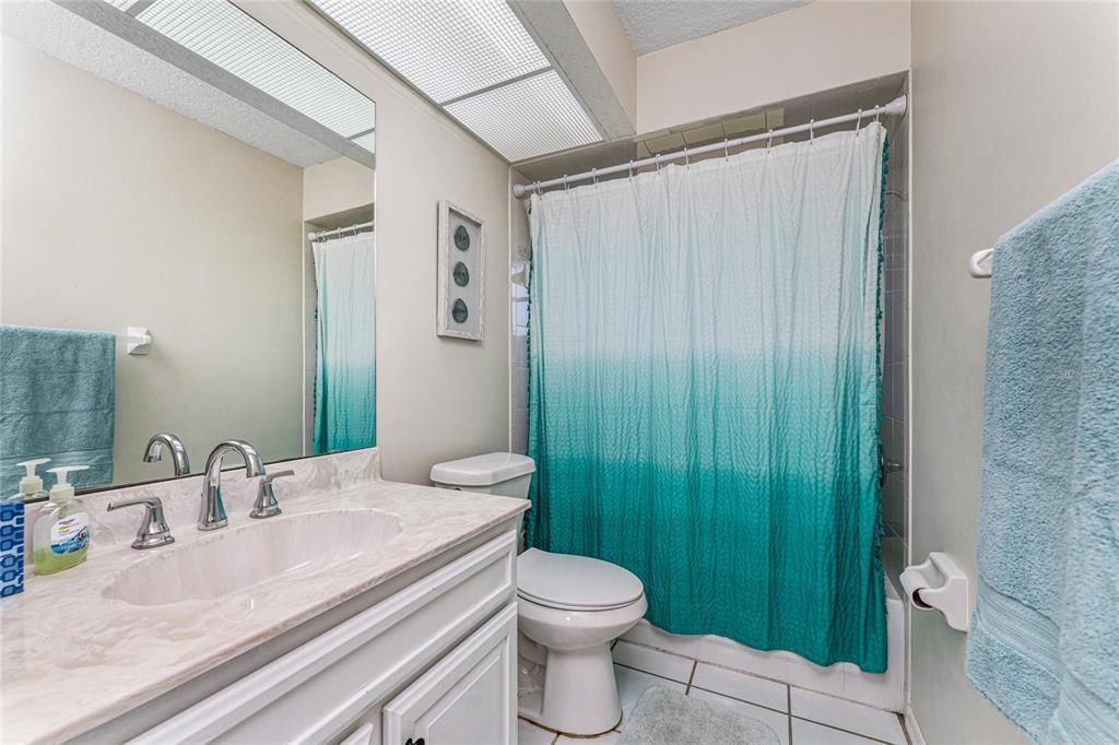 Guest Bath Has A Large Vanity And combo tub/shower.